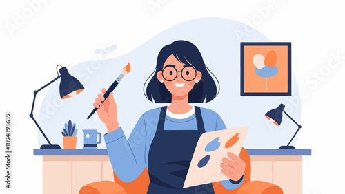 Artistic person in glasses with paintbrush and palette in a studio