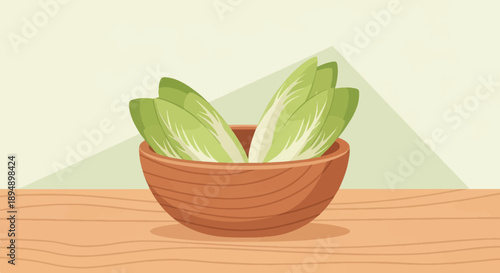 Bowl of fresh green chicory on wooden surface