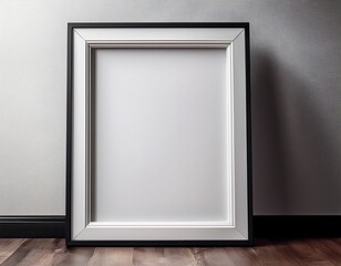 a white frame with a black border sits on a wooden floor
