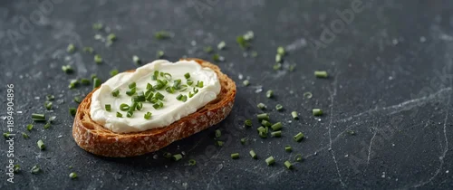 Panel kuchenny z motywem Healthy low fat cream cheese topped with chopped chives on a slice of freshly baked bread, low angle perspective