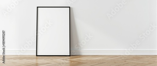 Mockup of a horizontal black thin picture frame on wooden poster frame, set on oak wooden parquet floor in minimal Scandinavian style with white wall and stucco decor