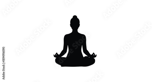 Silhouette of a woman practicing yoga in a meditative pose