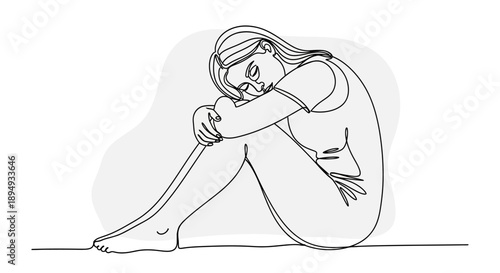 Woman Sitting on Floor with Head Down.