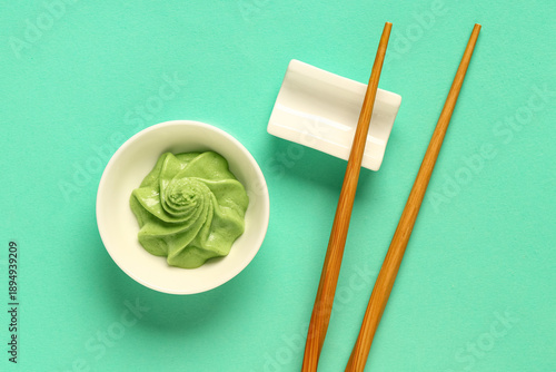 Bowl with wasabi paste and chopsticks on turquoise background © Pixel-Shot