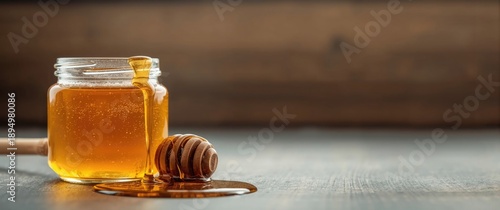 Jar of honey with drips on ...