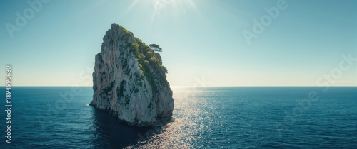 Rock formation standing vertically near Cyclone Beach in Pula, Croatia, featuring the Adriatic Sea, trees, and a clear summer sky