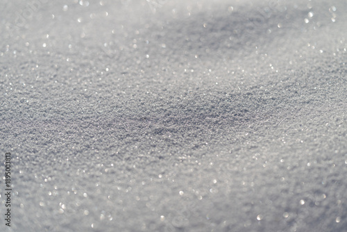 Crystalline snow grains with intense reflective gleam highcontrast macro texture, sparkling highlights for minimalist design or scientific reference, tactile visual interest
