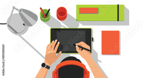 Artist's hands wearing headphones drawing on a graphic tablet with a stylus, desk with lamp and supplies