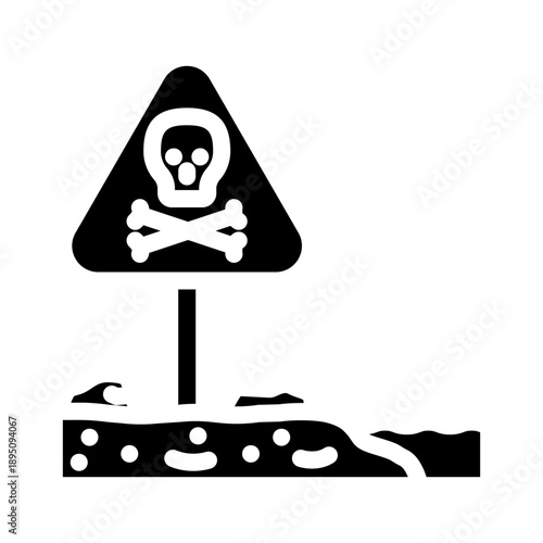 Skull and crossbones sign indicating danger on a plot of contaminated ground, symbolizing toxicity, pollution, and the presence of hazardous waste in an environmental context