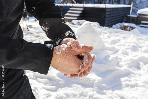 Male hands without gloves in winter.Risk of frostbite of hand outdoors during cold weather because of frost in winter.