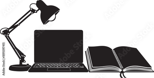 Workspace setup with lamp, laptop, and open book
