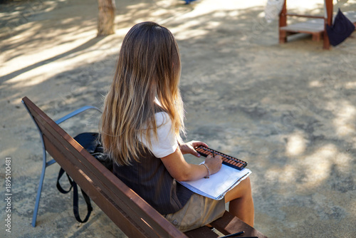 Mental arithmetic teacher practicing Abacus system outdoors, learning mathematics with abacus