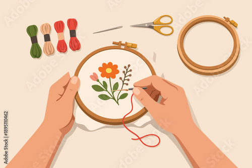 Hands embroidering floral pattern on fabric, creating art with needlework hobby