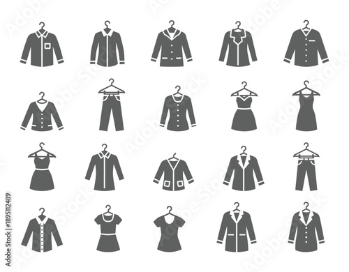 Various clothing items hanging on hangers a dark silhouette