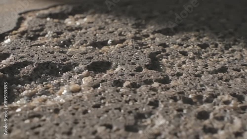 Extreme close up of very old damaged concrete showing weathered surface and exposed aggregate