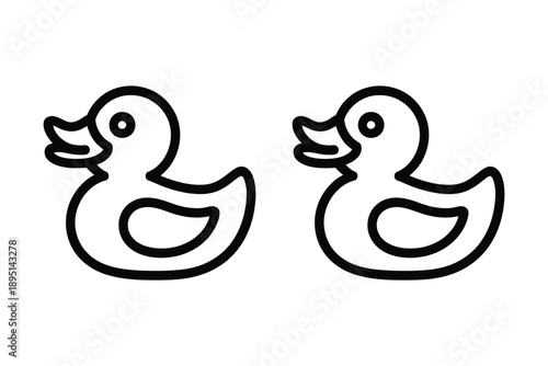 Two black and white rubber ducks facing each other on a plain background