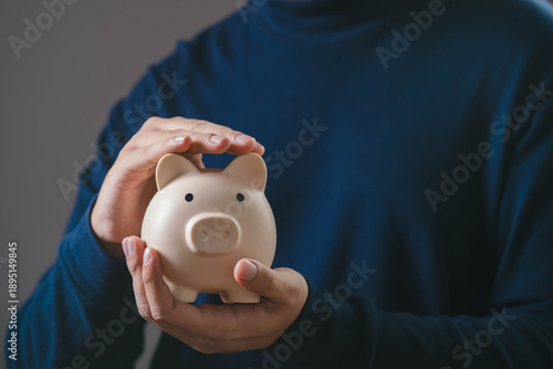 фотографія Hands protecting a piggy bank, representing financial security, saving money, wealth protection, personal finance planning, risk management, and long term financial stability concept