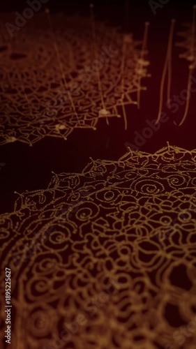 Detailed golden ornate swirling pattern on a deep red textured background