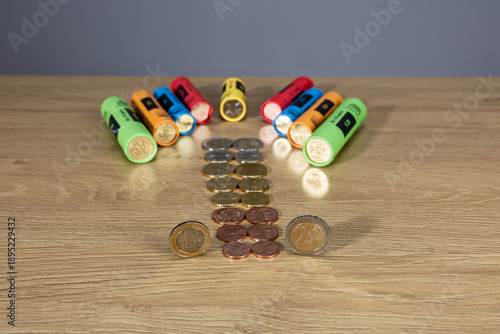 New collection of Bulgarian euro cents photographed on a wooden table. Colorful vertical columns with coins in denominations: 5, 10, 20, 50 cents and 1 euro. Selective focus and close-up.