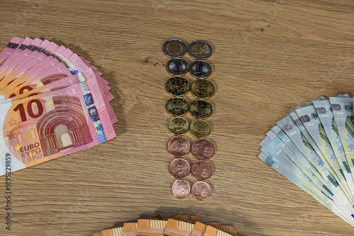 New collection of euro cent coin sets isolated on wooden background, European Union 2026. Colorful columns with coins in denominations: 5, 10, 20, 50 cents, 1, 2 euros and paper 5, 10, and 50 euros. B