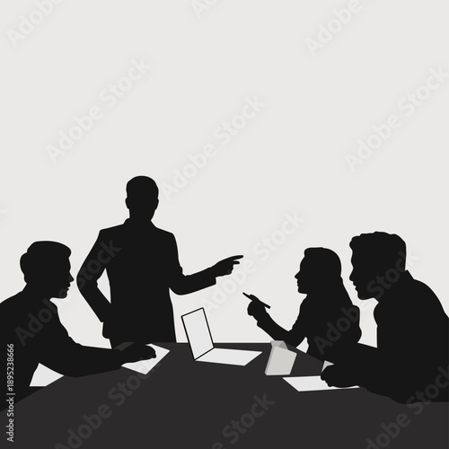 Silhouette of four people in a business meeting with a laptop on the table