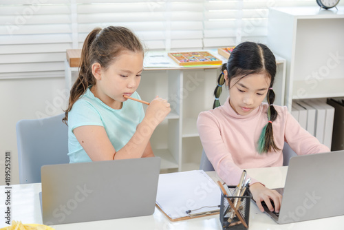 Cuadro en lienzo Education learning children home technology concept shows two girls studying tog