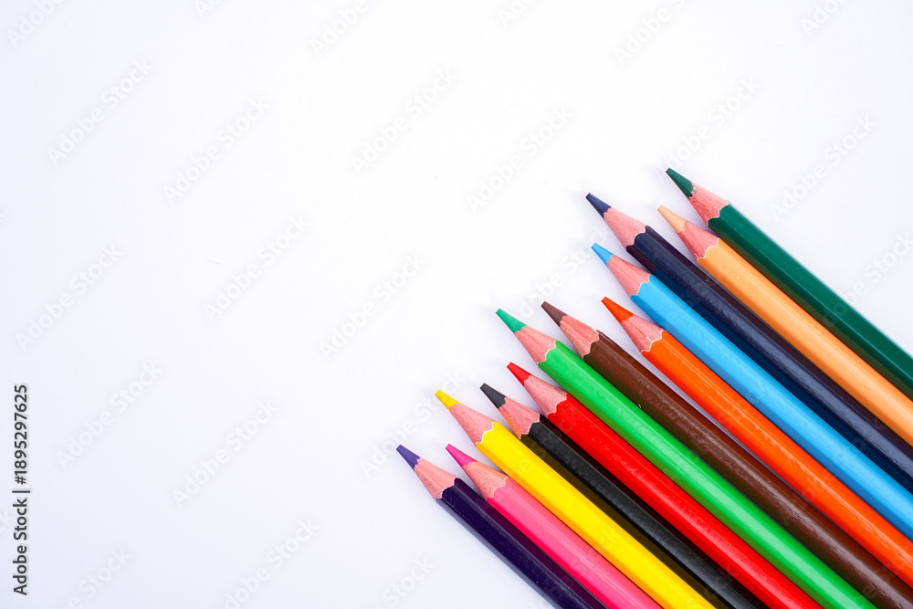 Fototapeta premium colorful pencils arranged in a row on a white background
