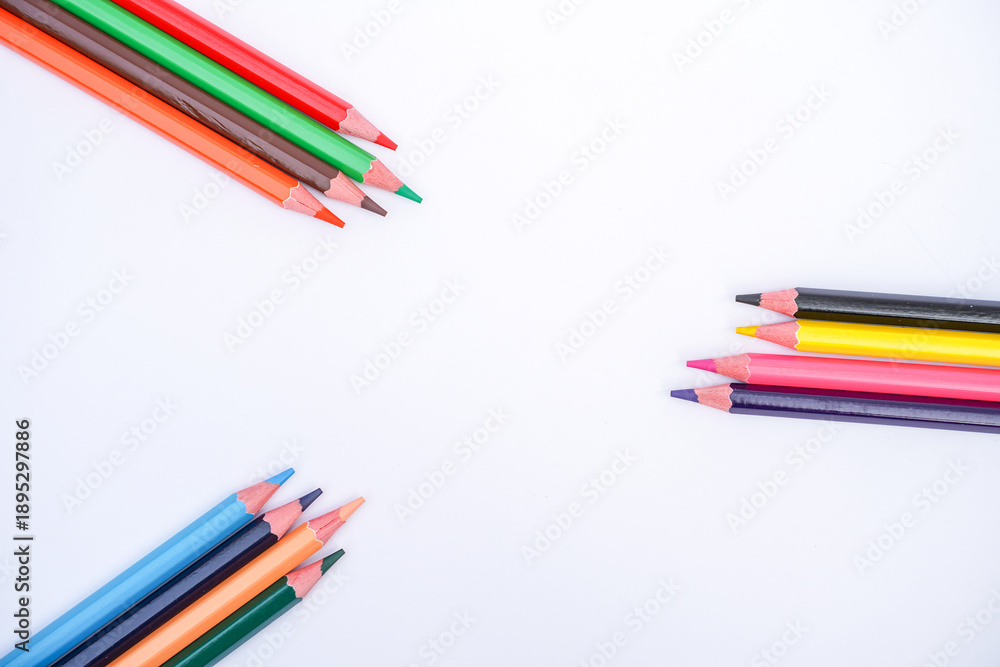 Fototapeta premium Various colored pencils scattered on a white background