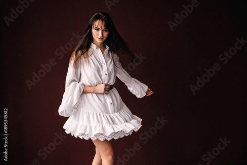 girl in a white dress with a lace whirling and look at camera. p