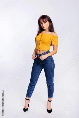 woman in yellow blouse and blue jeans, isolated on white. fashio