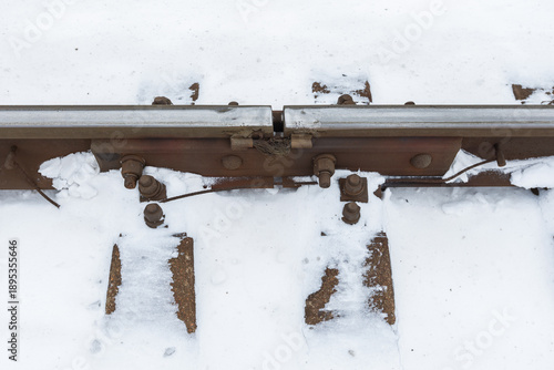 Wallpaper Mural Rusty rails and bolts lie in a snow-filled scene, showing weathered metal Torontodigital.ca