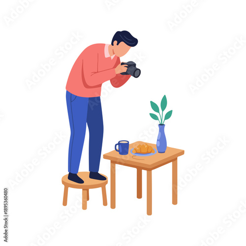 Man taking photo of food and drink on a table, capturing a moment.