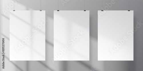 Realistic vector mockup of three white vertical A4 posters with soft shadows of window inside empty minimalistic interior. Print or product presentation template