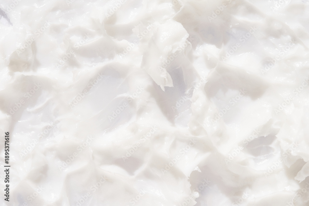 Obraz premium Creamy white texture background with soft, swirling patterns for beauty and skincare themes.