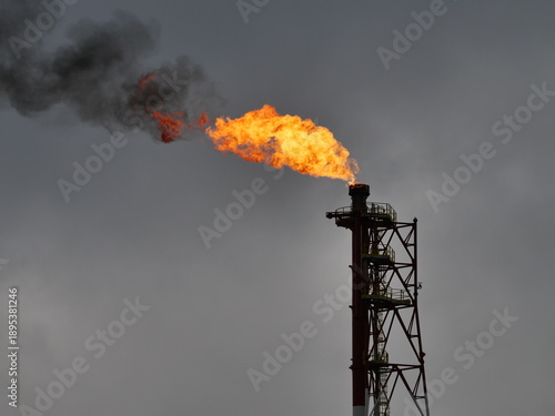   refinery fire gas torch on sky background