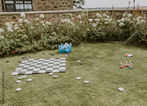 Garden games laid out on a lawn including chess and hoopla