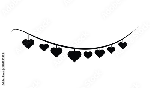 Black silhouette of heart shapes hanging on a string, creating a festive garland