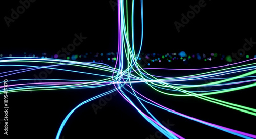 Dynamic bright neon light trails in blue, green, and purple colors flow horizontally across a dark background, creating an abstract and energetic visual.