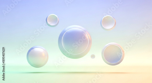 Various sizes of glossy, iridescent pastel-colored spheres and rings float gracefully in a soft, ethereal gradient background.