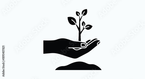 Black silhouette of a hand holding a small plant growing out of soil