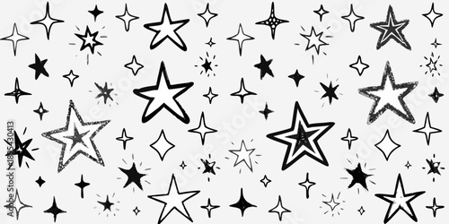 A scattering of hand drawn stars and sparkles on a white background