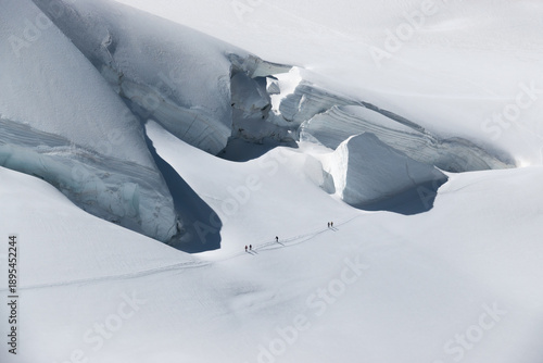 Photos Climbers traversing the Monte Rosa glacier beneath towering seracs in the Alps