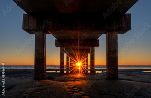 Dramatic Sunburst underneath Fishing Pier