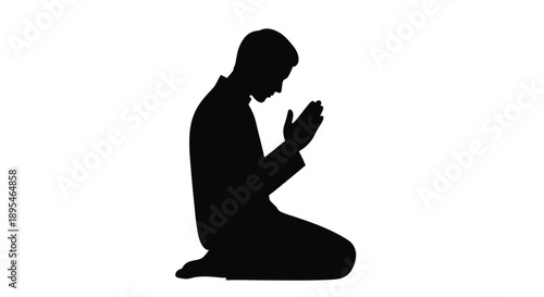 A silhouetted man kneeling in a praying or respectful posture