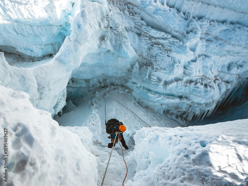Tableau sur toile Climber descending into a crevasse on Island Peak Imja Tse Nepal Himalayas