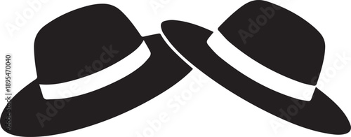 Two black fedoras with white bands placed side by side on a clean surface