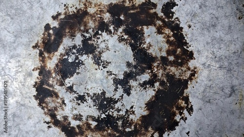 Close up burnt pan bottom texture, metallic scorched surface for grunge background, industrial pattern, and vintage design assets.