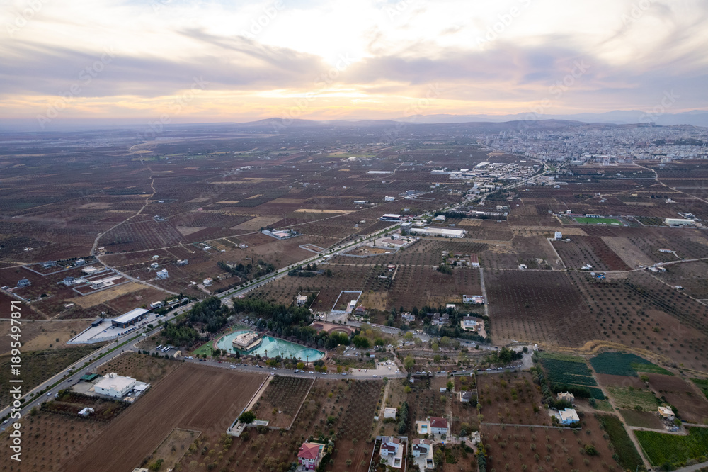 Obraz premium Aerial View of Sogutludere Recreation Area Park and Restaurant Complex Surrounded by Vast Olive Groves in Rural Kilis Landscape