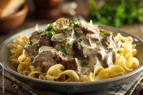 Wallpaper Mural Creamy beef stroganoff over pasta with mushroom sauce, rustic wooden table setting Torontodigital.ca