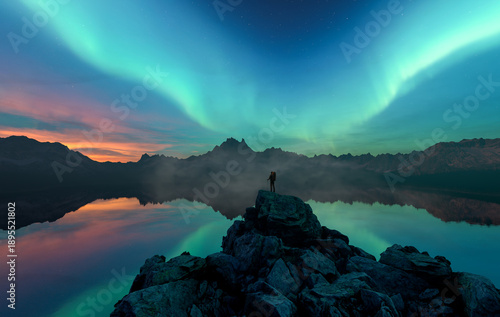 Hiker On Rocky Outcrop Under Aurora Borealis Over Mountain Range With Lake Reflection